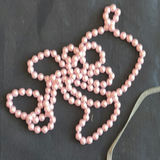 Assorted necklaces: pink pearl strand, colorful beaded necklace, and wood pendant necklace - thumbnail 4 of 5