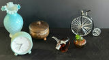 Mint-green clock, teal ruffled vase, brass-lidded container, penny-farthing bicycle sculpture, amber decanter, and glass pumpkin - thumbnail 2 of 6