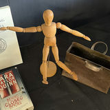 Assorted vintage books, a wooden mannequin, and a metal tote - thumbnail 4 of 5
