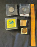 Collection of mining-related coins and medals in display cases - thumbnail 1 of 6