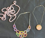 Assorted necklaces: pink pearl strand, colorful beaded necklace, and wood pendant necklace - thumbnail 5 of 5