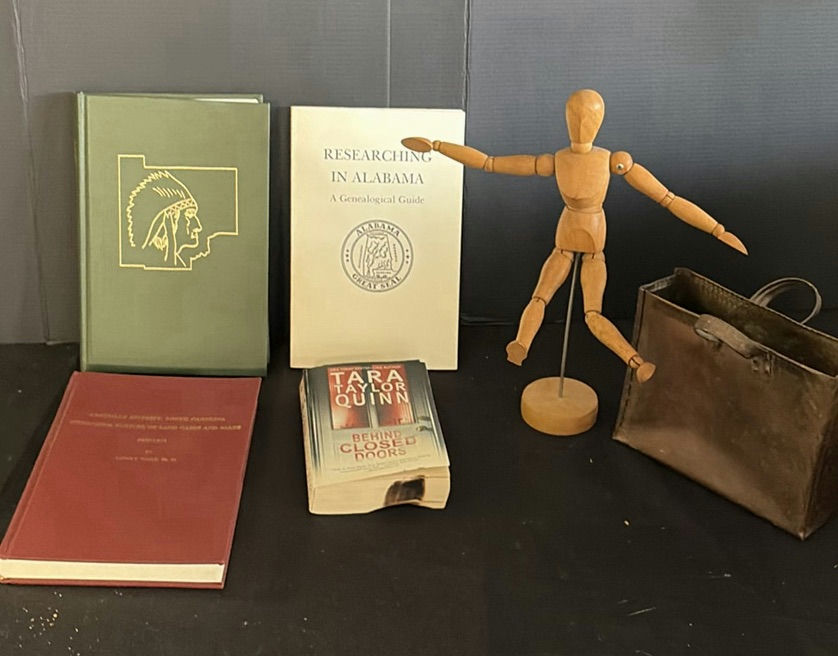Assorted vintage books, a wooden mannequin, and a metal tote - image 1 of 5