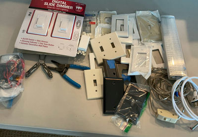 Assorted lighting switches, dimmers, wall plates, and wiring hardware - Image 1 of 5