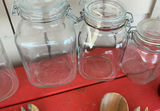 Assorted glass jars, bottles, and wooden kitchen utensils - thumbnail 3 of 6