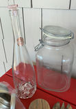 Assorted glass jars, bottles, and wooden kitchen utensils - thumbnail 2 of 6