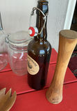 Assorted glass jars, bottles, and wooden kitchen utensils - thumbnail 4 of 6