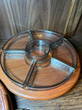Vintage kitchenware collection: glass segmented serving tray, ceramic pot on burner stand, carved wooden serving piece, and metal scroll trivet - thumbnail 2 of 6