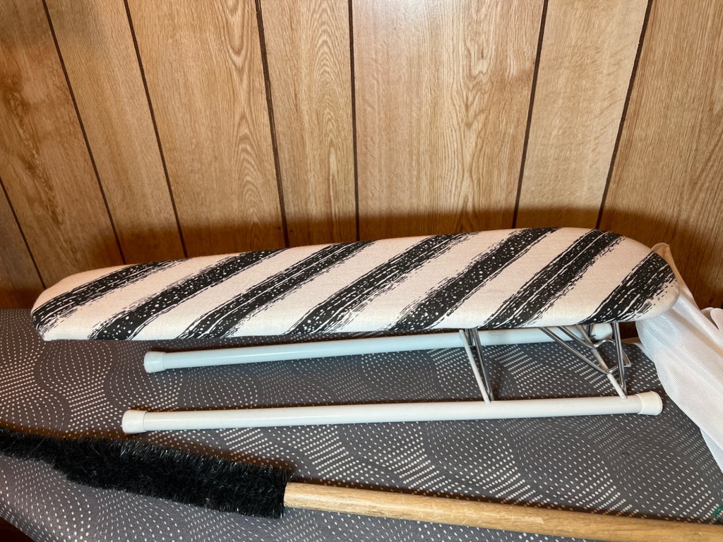Ironing board setup with iron, cleaning supplies, and plastic storage bins - image 2 of 6
