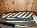Ironing board setup with iron, cleaning supplies, and plastic storage bins - thumbnail 2 of 6
