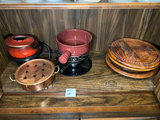 Vintage kitchenware collection: glass segmented serving tray, ceramic pot on burner stand, carved wooden serving piece, and metal scroll trivet - thumbnail 1 of 6