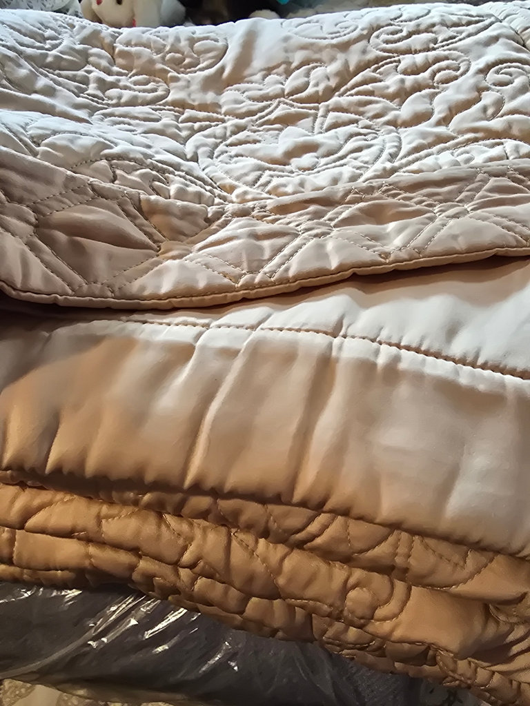 Stacked quilts and blankets - image 5 of 8
