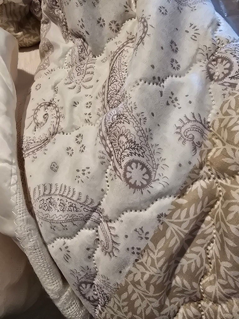 Stacked quilts and blankets - image 1 of 8