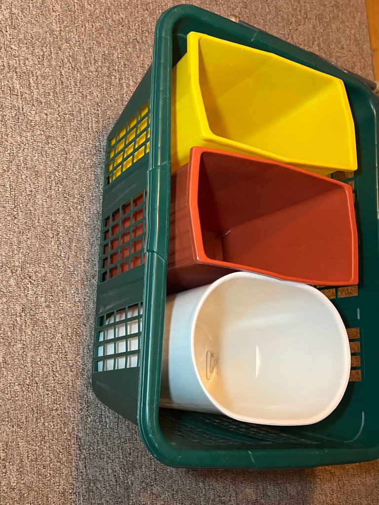 Ironing board setup with iron, cleaning supplies, and plastic storage bins - image 4 of 6