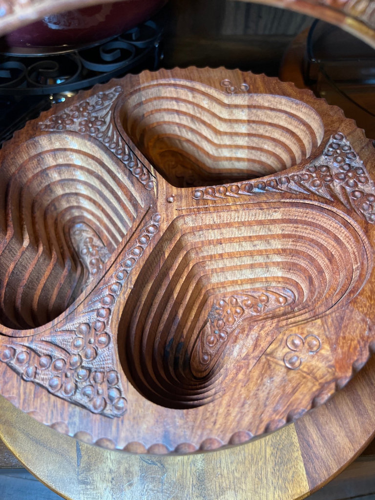 Vintage kitchenware collection: glass segmented serving tray, ceramic pot on burner stand, carved wooden serving piece, and metal scroll trivet - image 6 of 6