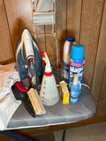 Ironing board setup with iron, cleaning supplies, and plastic storage bins - thumbnail 5 of 6