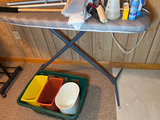 Ironing board setup with iron, cleaning supplies, and plastic storage bins - thumbnail 1 of 6