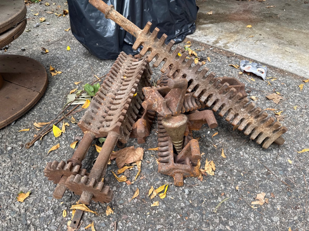 Rusty antique farm harrow teeth and iron implements - image 1 of 5