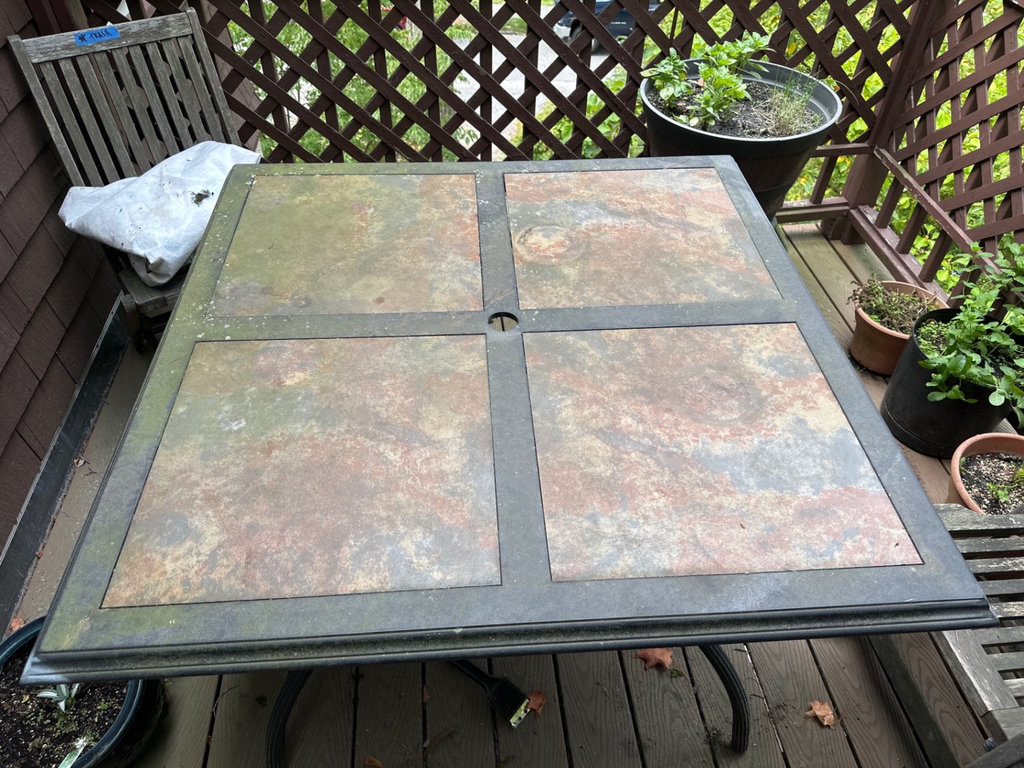 Outdoor black metal dining table with four-panel top - image 1 of 4