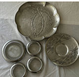 Two pressed aluminum plates with a tropical theme, and silver plate and cut glass coasters. - thumbnail 1 of 3