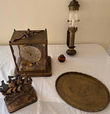 Antique mantel clock, lantern lamp, engraved tray, ship sculpture, angel candlesticks, and alcohol lamp bottle - thumbnail 1 of 8