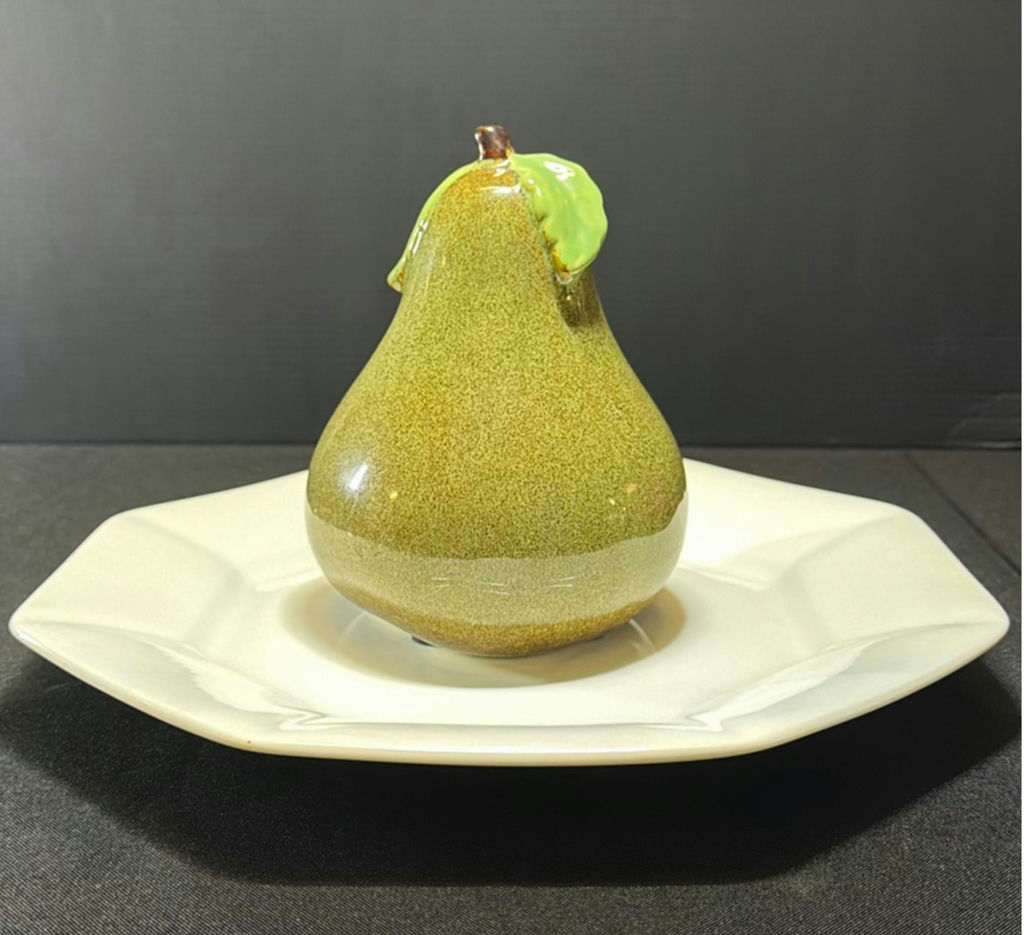 Ceramic pear-shaped figurine on white plate - image 1 of 5