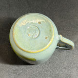 Teal-blue glazed ceramic tea service with hand-painted figures and cactus motifs - thumbnail 8 of 12
