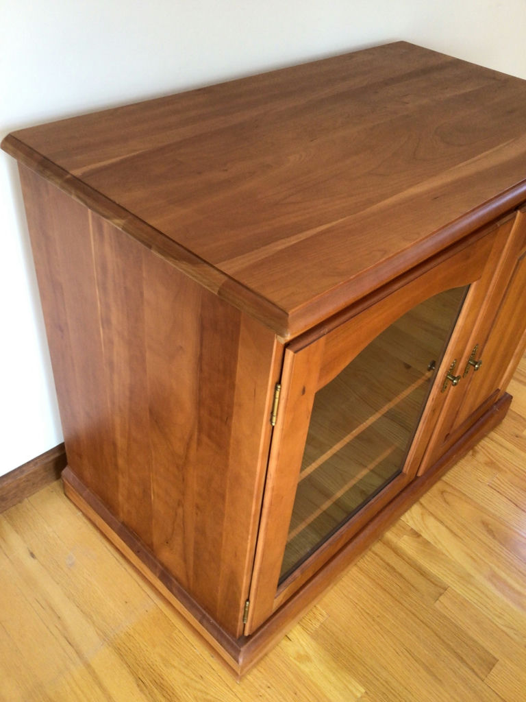 Wooden cabinet with glass-front left compartment and solid right door - image 2 of 3