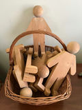 Wooden humanoid figures in wicker basket - thumbnail 1 of 1