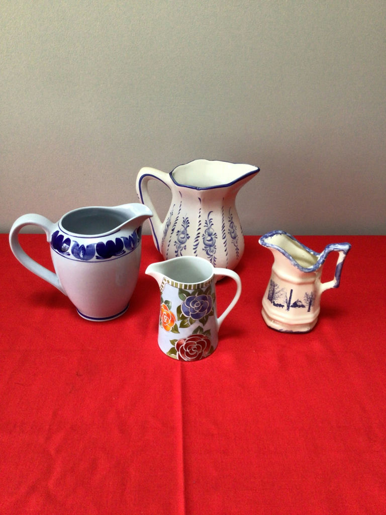 Assorted ceramic pitchers and a floral mug - image 1 of 3