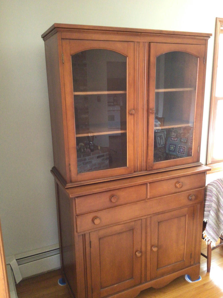 Wooden china cabinet with glass-front upper section and lower storage - image 1 of 3
