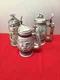 Collection of decorative beer steins with pewter lids - thumbnail 1 of 7