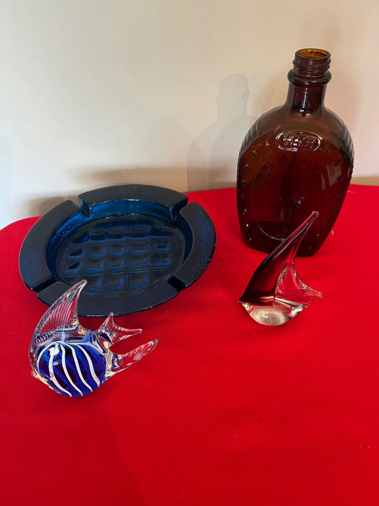 Glass art pieces including blue striped fish, blue ashtray, brown sailboat, brown bottle, and blue ashtray - image 1 of 1