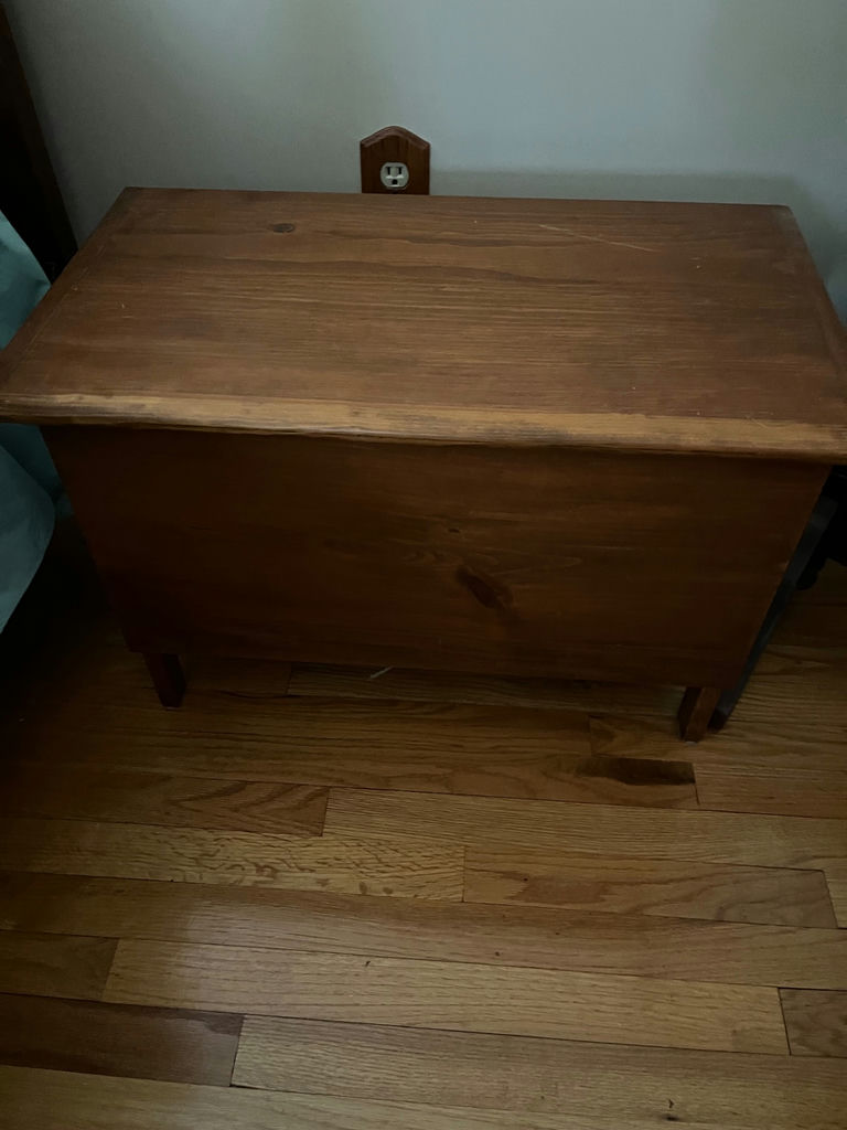 Wooden storage chest with folded linens - image 1 of 2