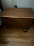 Wooden storage chest with folded linens - thumbnail 1 of 2