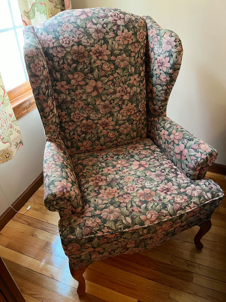 Floral patterned wingback armchair and small oval footstool - image 1 of 3