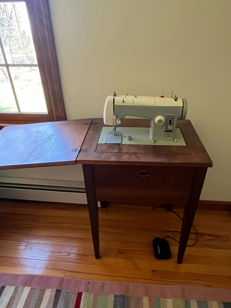 Vintage sewing machine on wooden table  - Sears Kenmore - image 1 of 2