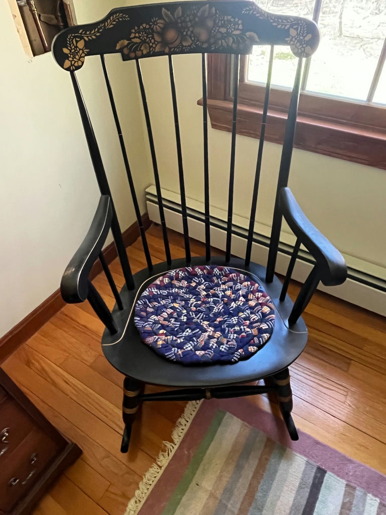 Black wooden rocking chair with floral back and woven cushion - image 1 of 2