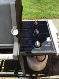 Weber gas grill on a wheeled cart with propane tank - thumbnail 2 of 4