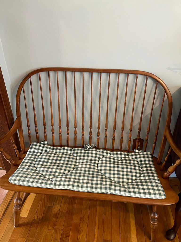 Wooden spindle-back bench with plaid cushion - image 1 of 1