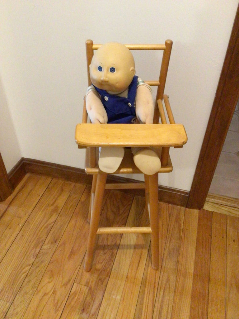 Wooden high chair with a doll - image 1 of 2
