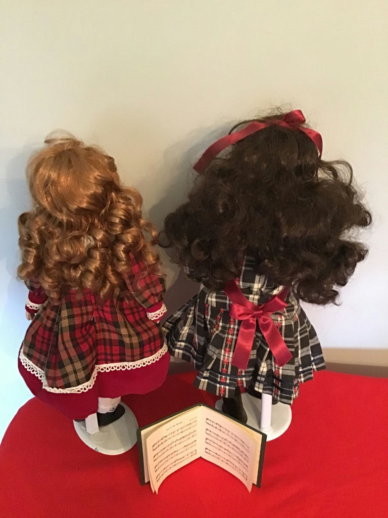 Two caroler dolls in plaid dresses with an open music book - image 2 of 2