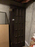 Black grid-pane door with window frame and plywood panel - thumbnail 2 of 3