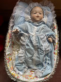 Porcelain baby doll in blue lace-trimmed gown in wicker cradle - thumbnail 2 of 6
