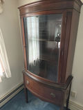 Dark wood corner display cabinet with glass doors and bottom drawer - thumbnail 1 of 3