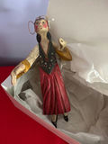 Hand-painted wooden folk-art figurine of a woman in a red dress with wings - thumbnail 1 of 4