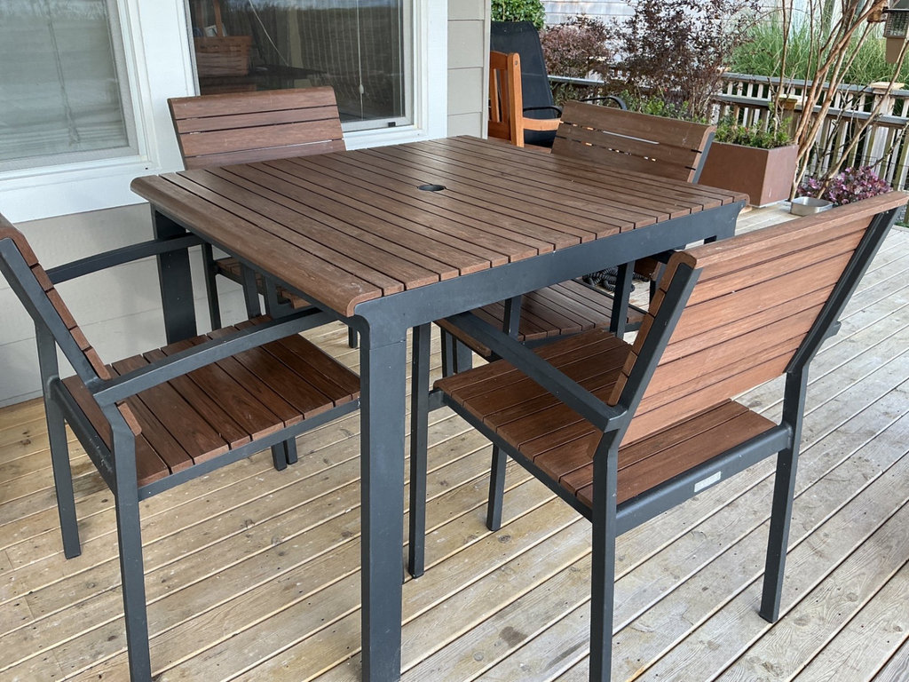Crate & Barrel Outdoor dining table with four wooden slat chairs - image 1 of 8