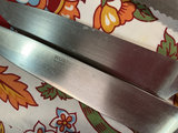 Cast-iron pizza pan, four kitchen knives, cookbooks, and decorative textiles - thumbnail 1 of 6
