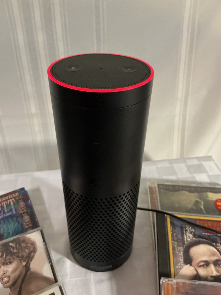 Amazon Echo with a collection of music CDs - image 2 of 3