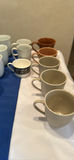 Assorted Ceramic Mugs, Teapots, and Saucers - thumbnail 2 of 7