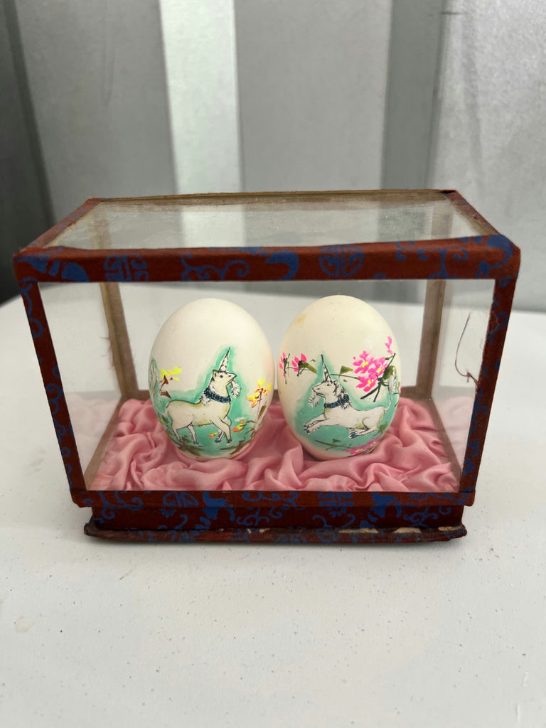 Geisha figurine, oval landscape plaque, and two painted eggs in glass display - image 4 of 6